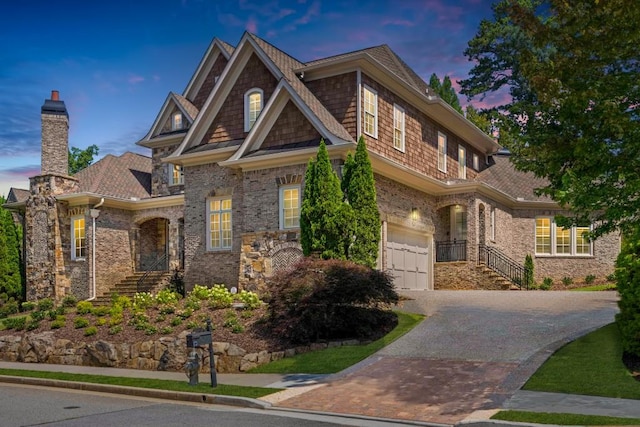 craftsman-style house with a garage and decorative driveway