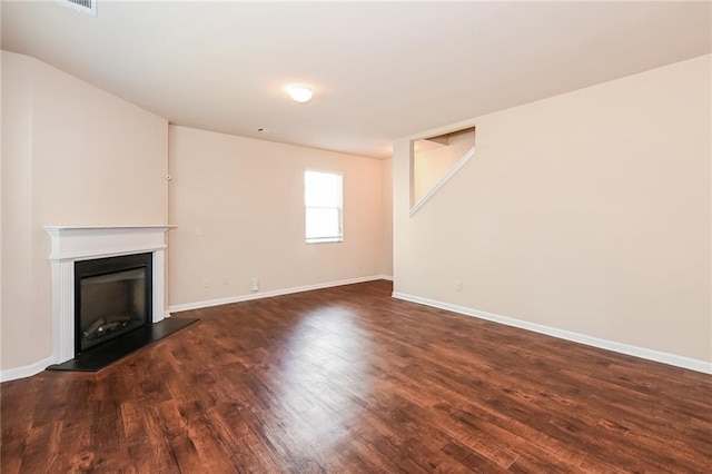 unfurnished living room featuring dark hardwood / wood-style flooring