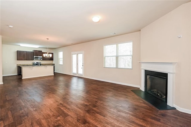 unfurnished living room with dark hardwood / wood-style flooring