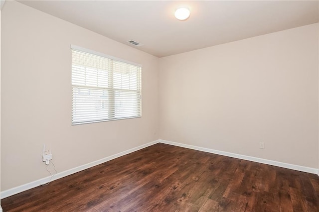 spare room featuring dark hardwood / wood-style flooring