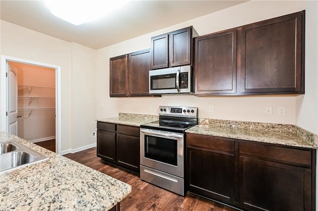 kitchen featuring stainless steel appliances and dark brown cabinets