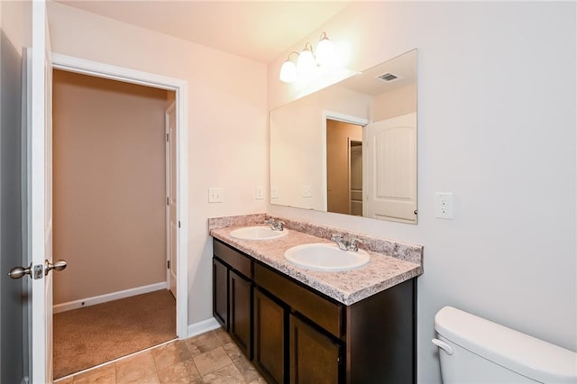 bathroom with toilet and vanity