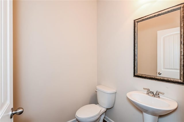 bathroom featuring toilet and sink