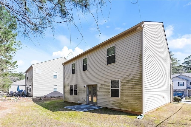 rear view of property with a yard