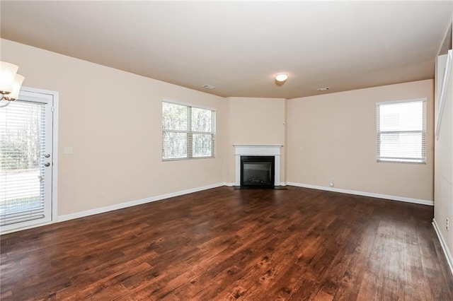 unfurnished living room with dark hardwood / wood-style floors