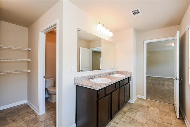 bathroom with toilet and vanity