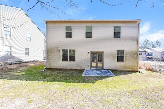 back of house with a lawn