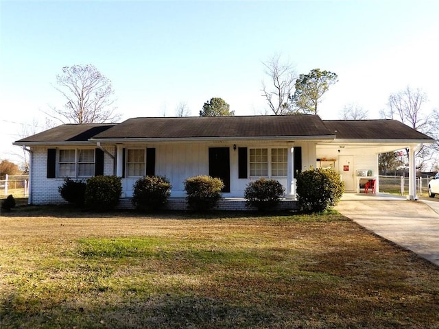 ranch-style house featuring a carport and a front lawn