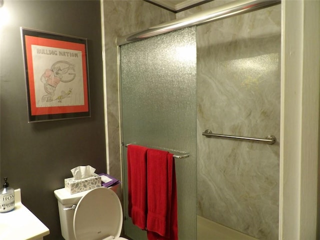 bathroom with vanity, an enclosed shower, and toilet