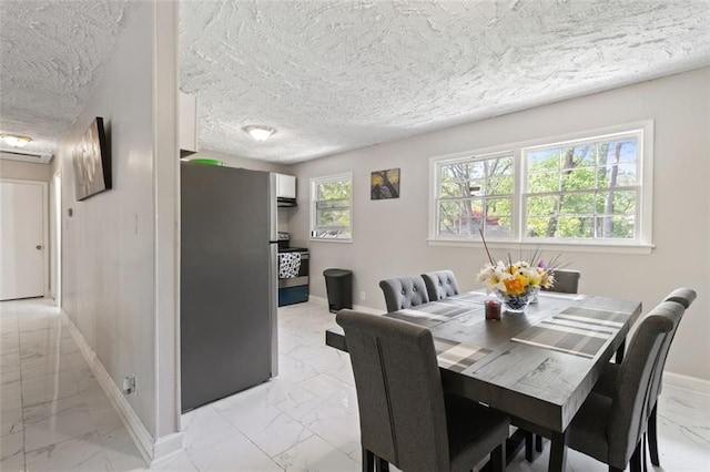 dining space featuring a textured ceiling