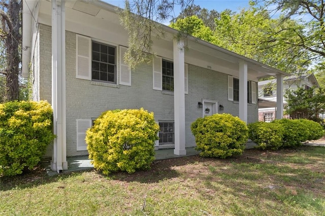 view of home's exterior with a yard