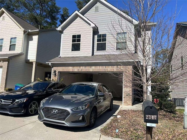 view of front facade featuring a garage, concrete driveway, and brick siding