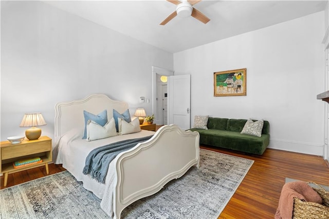 bedroom with wood finished floors, ceiling fan, and baseboards