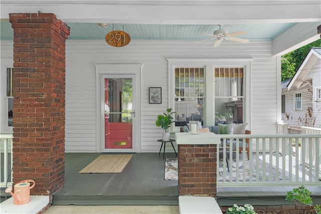 view of exterior entry with a ceiling fan