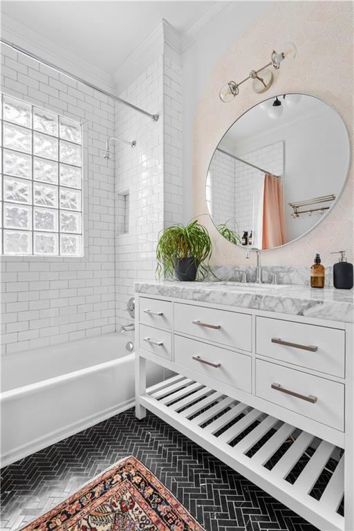 bathroom featuring crown molding, shower / tub combo with curtain, and vanity