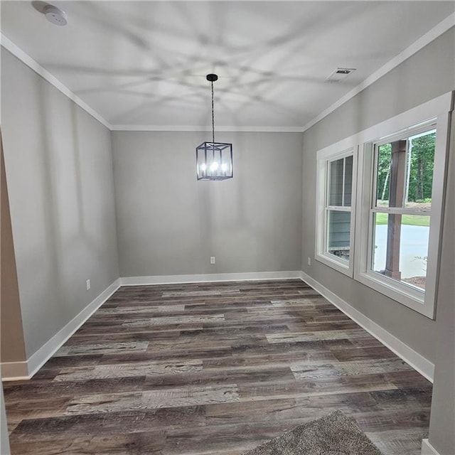 6093 Wayarer Dr, Villa Rica, GA 30180 - unfurnished dining area with ornamental molding, dark wood-type flooring, baseboards, and a chandelier