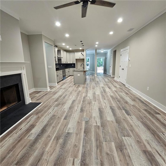 6093 Wayarer Dr, Villa Rica, GA 30180 - unfurnished living room featuring a sink, a ceiling fan, recessed lighting, light wood-type flooring, and baseboards