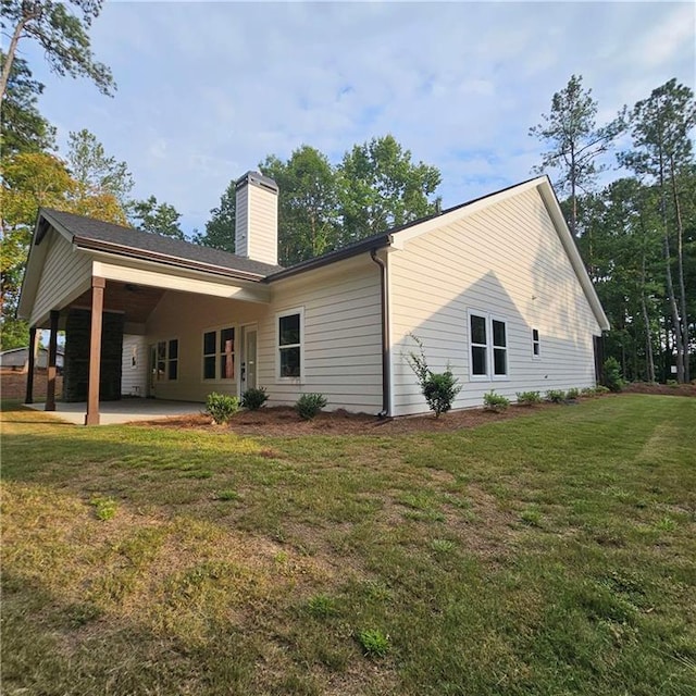 6093 Wayarer Dr, Villa Rica, GA 30180 - rear view of property with a chimney, a yard, and a patio area