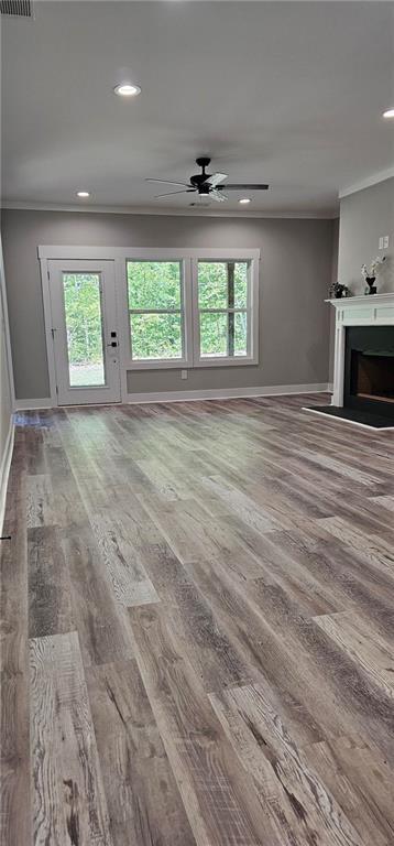 6093 Wayarer Dr, Villa Rica, GA 30180 - unfurnished living room featuring crown molding, wood finished floors, a ceiling fan, baseboards, and recessed lighting