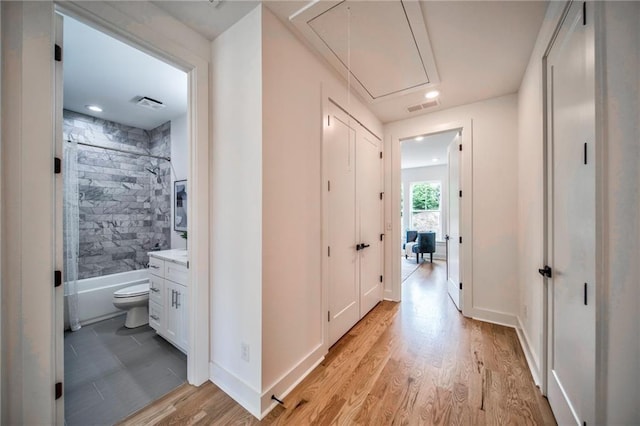 corridor featuring light hardwood / wood-style floors