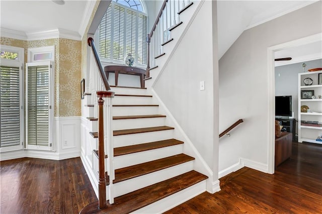 stairway with crown molding and hardwood / wood-style floors