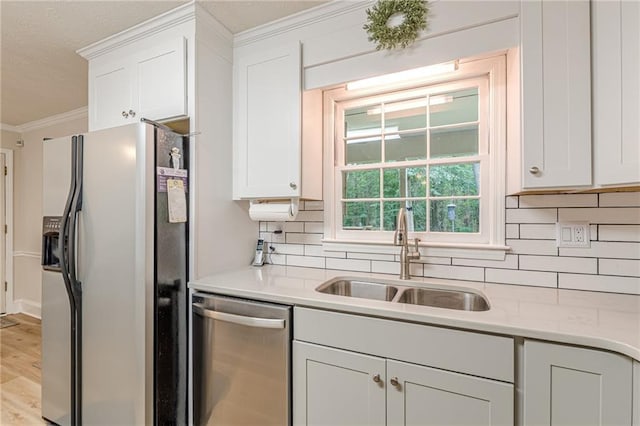 1667 Quail Run, Conyers, GA 30094 - kitchen featuring refrigerator with ice dispenser, stainless steel dishwasher, crown molding, decorative backsplash, and white cabinetry