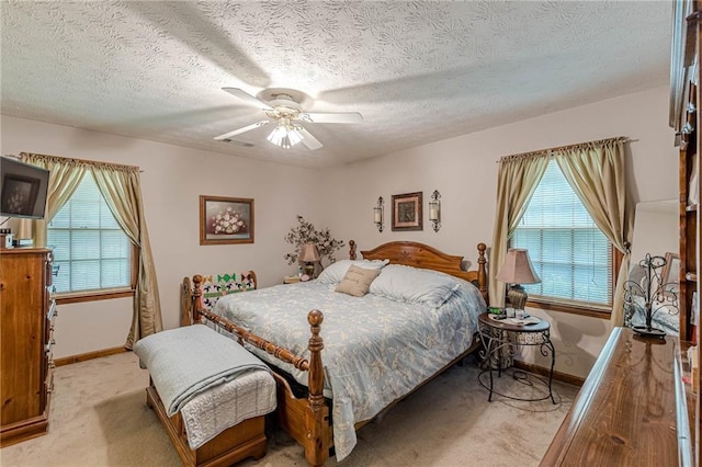 1667 Quail Run, Conyers, GA 30094 - bedroom featuring light carpet, multiple windows, ceiling fan, and a textured ceiling