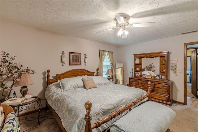 1667 Quail Run, Conyers, GA 30094 - bedroom with light carpet, a textured ceiling, and a ceiling fan