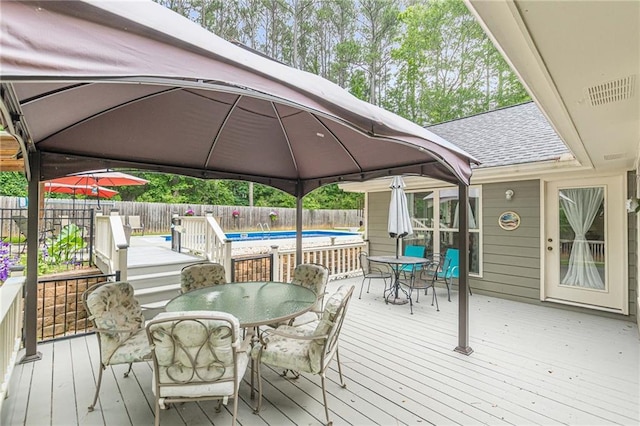 1667 Quail Run, Conyers, GA 30094 - deck with outdoor dining area, a gazebo, and a fenced backyard