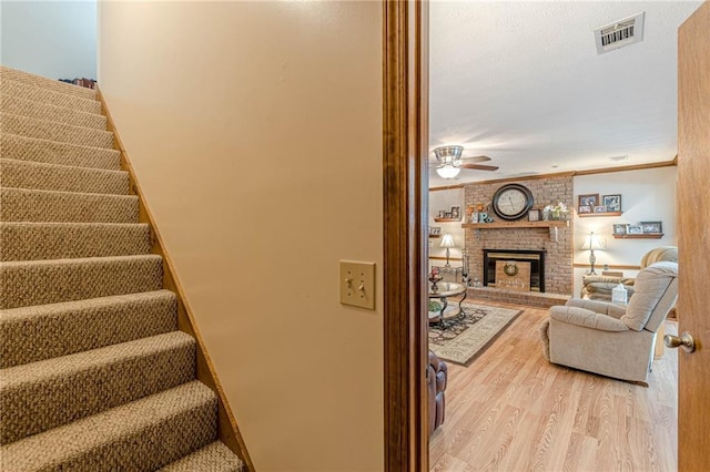 1667 Quail Run, Conyers, GA 30094 - stairs with wood finished floors, ceiling fan, a brick fireplace, and ornamental molding