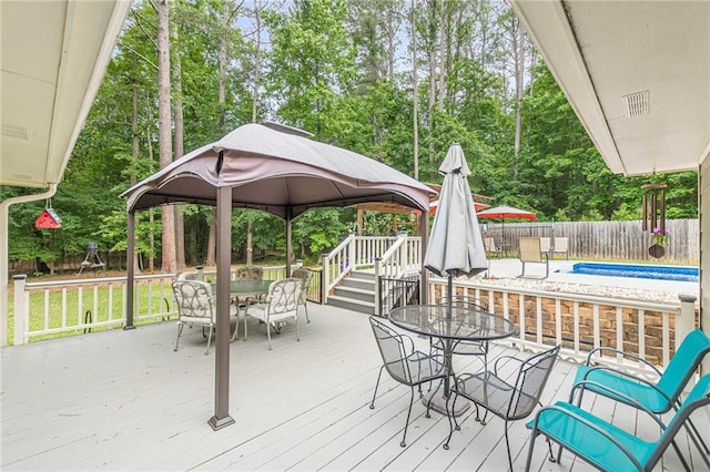 1667 Quail Run, Conyers, GA 30094 - deck featuring outdoor dining area, a gazebo, a fenced backyard, and view of scattered trees