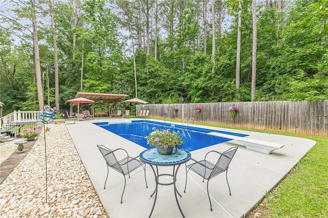 1667 Quail Run, Conyers, GA 30094 - view of pool with a fenced backyard, a diving board, a patio, a gazebo, and view of scattered trees