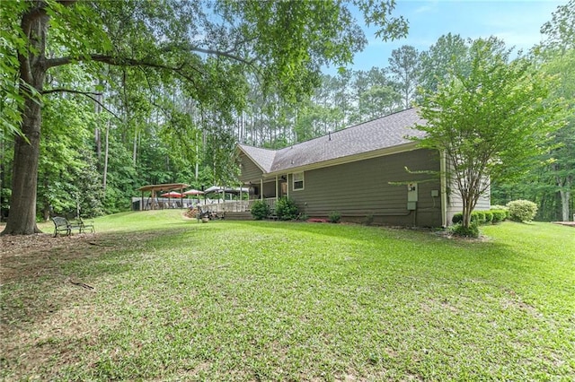1667 Quail Run, Conyers, GA 30094 - view of green lawn with a wooden deck and a carport