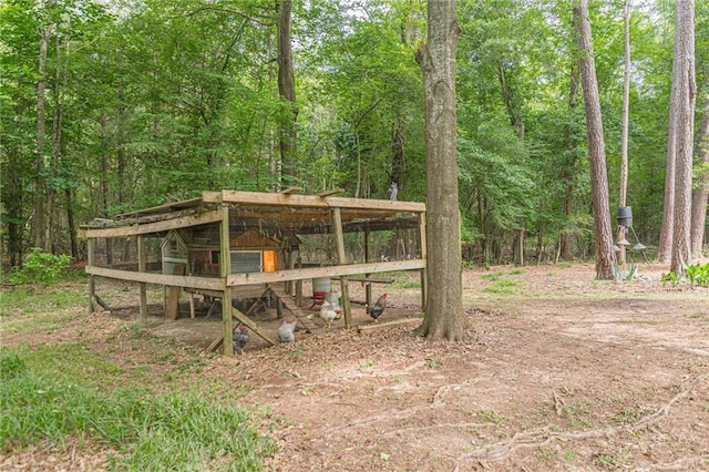 1667 Quail Run, Conyers, GA 30094 - view of yard with exterior structure, an outbuilding, and a forest view