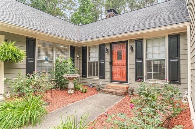 1667 Quail Run, Conyers, GA 30094 - view of exterior entry featuring a shingled roof and a chimney