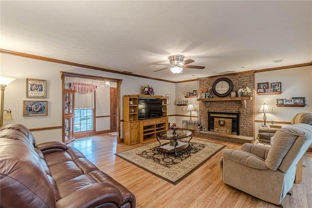 1667 Quail Run, Conyers, GA 30094 - living area featuring ceiling fan, light wood-type flooring, a textured ceiling, and a brick fireplace