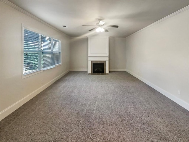 unfurnished living room featuring a tiled fireplace, light carpet, crown molding, and baseboards