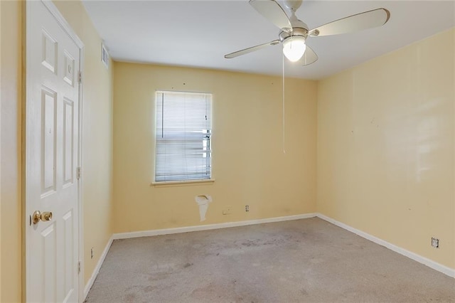 carpeted spare room featuring ceiling fan