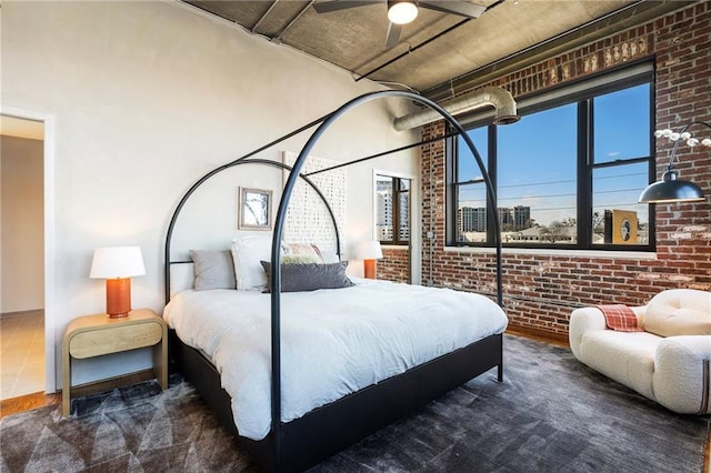 bedroom featuring brick wall