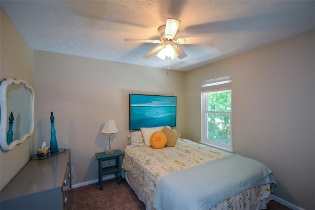 carpeted bedroom with a textured ceiling and ceiling fan