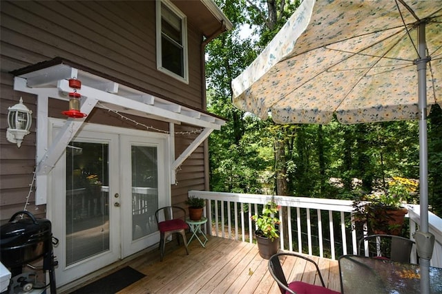 wooden terrace featuring a grill and french doors