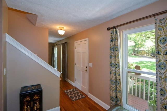 entrance foyer with wood-type flooring and a textured ceiling