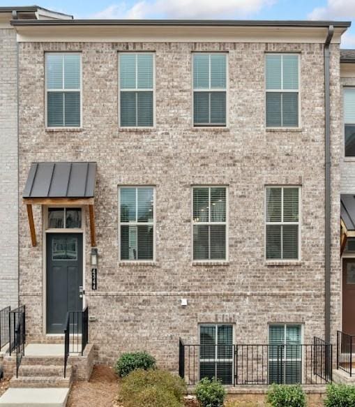 view of front of house featuring brick siding