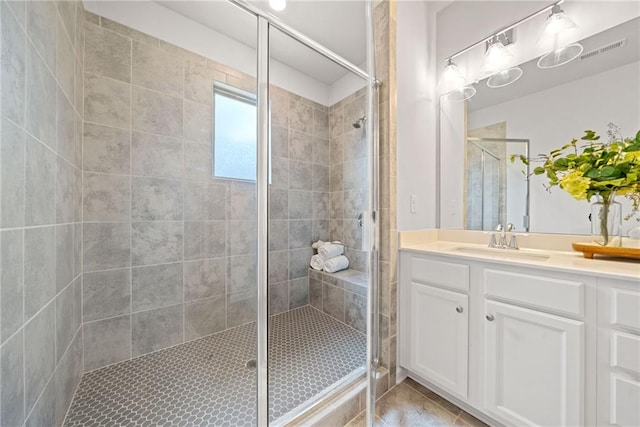 full bathroom featuring a shower stall, vanity, and tile patterned floors