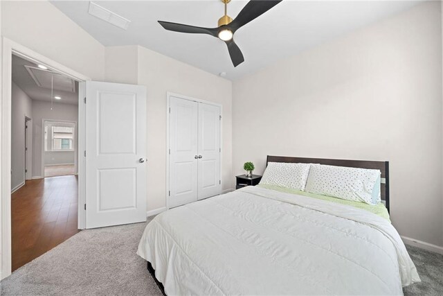 bedroom with visible vents, carpet floors, a closet, and attic access