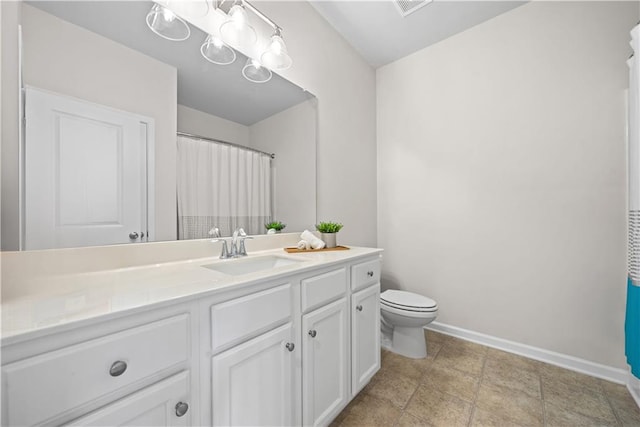 bathroom with visible vents, toilet, vanity, and baseboards