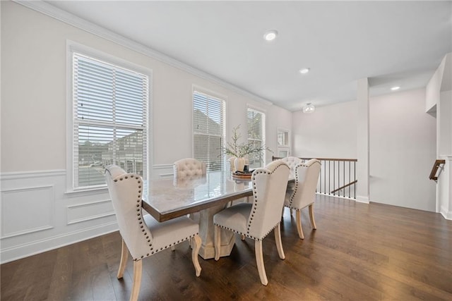 dining area with a wainscoted wall, a decorative wall, dark wood-type flooring, and recessed lighting