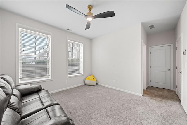 unfurnished room with carpet floors, visible vents, and baseboards