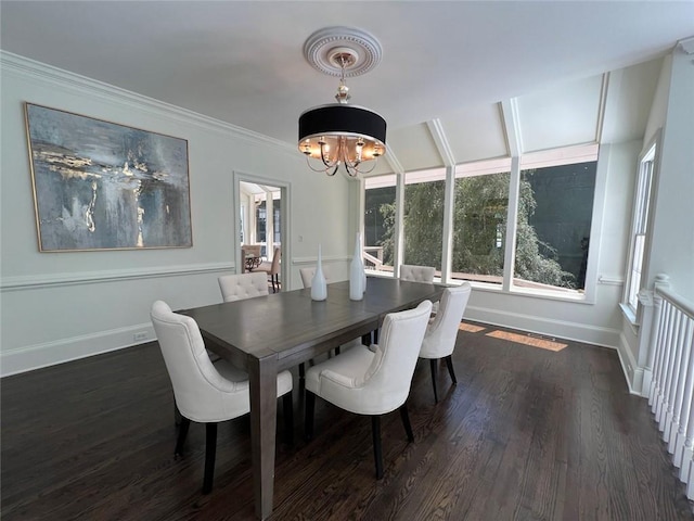 dining area featuring baseboards, a chandelier, dark wood-style flooring, and ornamental molding