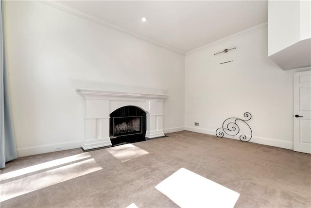 unfurnished living room with a fireplace with flush hearth, carpet, baseboards, and ornamental molding